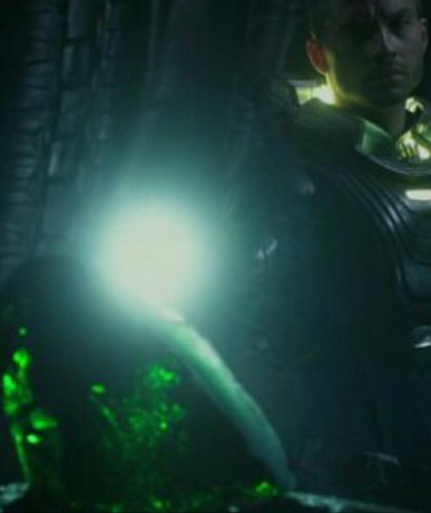 What is the purpose of the green gem/rock in the room with voles of black goo?
