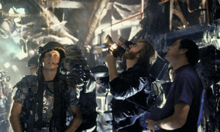 An old set photo from Aliens featuring James Cameron and cast